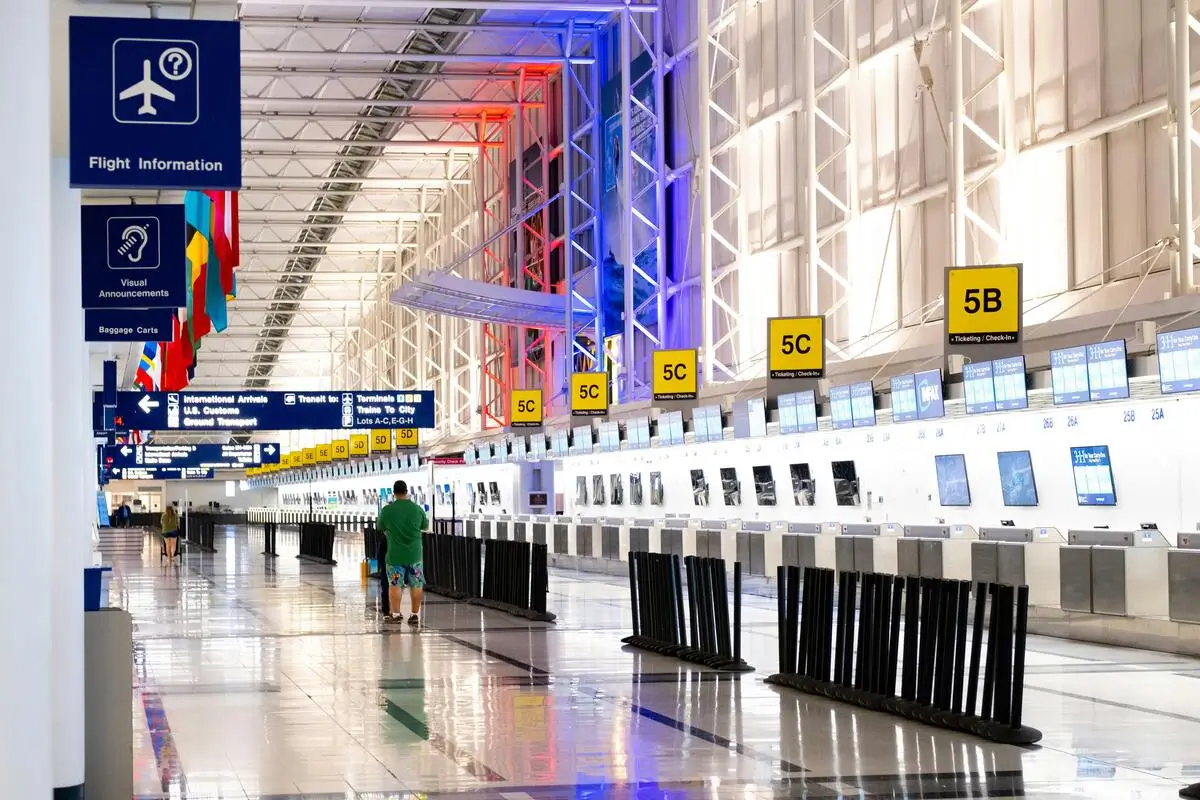 O’Hare Airport terminal interior with check-in counters — AJ Prestige pickup zone nearby