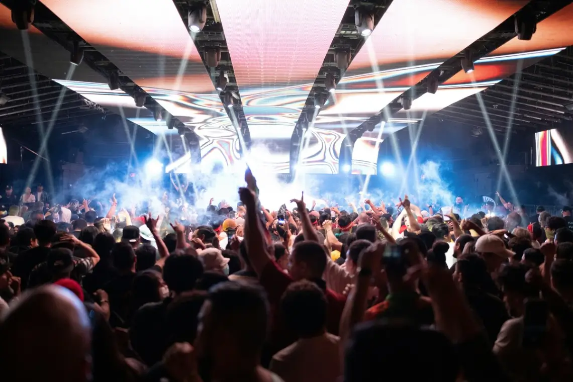Crowded LA nightclub with lights and music, ideal for AJ Prestige nightlife chauffeur service. 