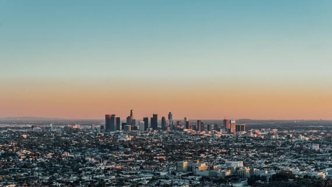 Downtown Los Angeles skyline at sunset, viewed from the hills—ideal for AJ Prestige chauffeur routes.