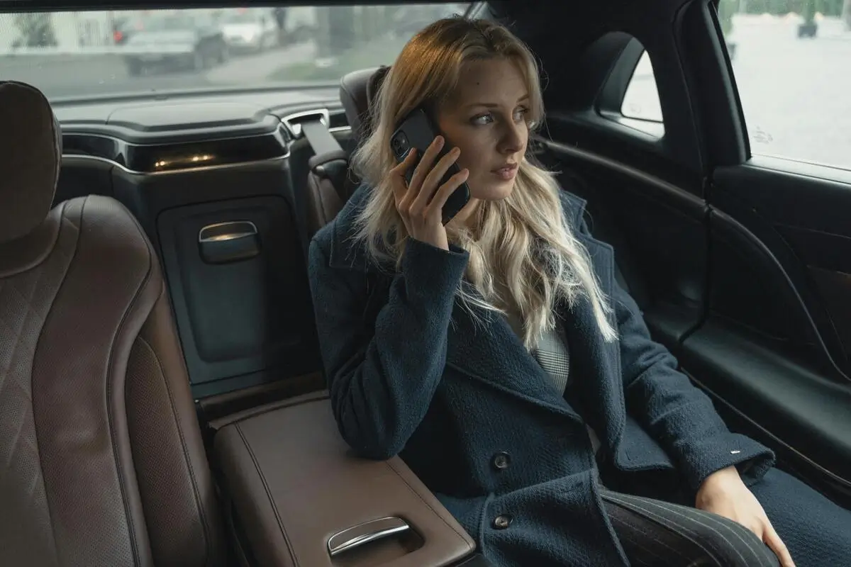 Executive woman relaxing in a luxury private car